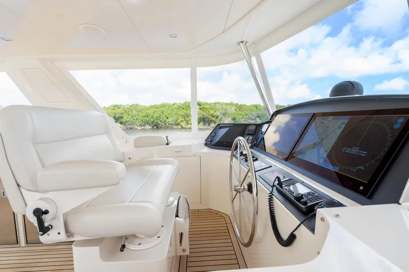 Slide: The Image of Luxurious helm of 2023 Fleming 85 yacht with advanced navigation displays and plush seating. - 38