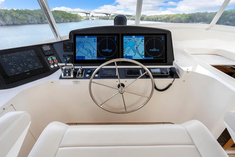 Slide: The Image of Helm of 2023 Fleming 85 yacht with navigation screens and steering wheel. - 39