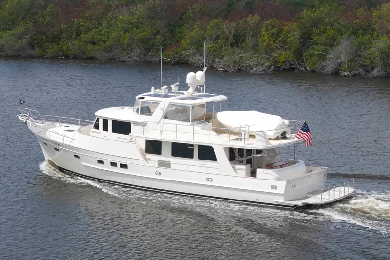 Slide: The Image of Luxurious 2023 Fleming 85 yacht cruising on a serene river. - 63