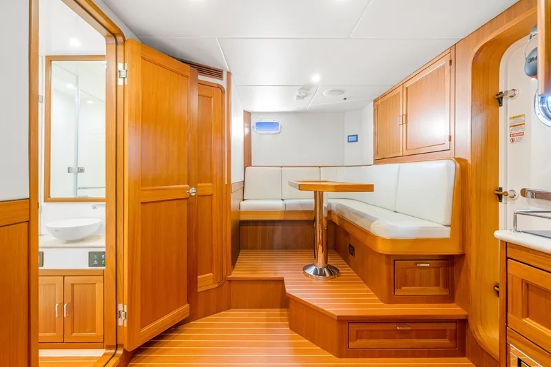 Slide: The Image of Luxurious interior of 2023 Fleming 85 yacht with wooden finishes and cozy seating area. - 65
