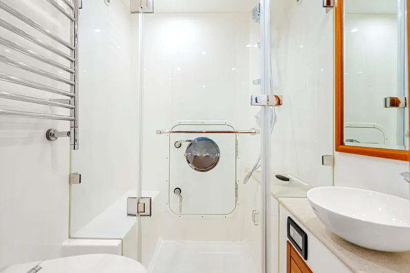 Slide: The Image of Modern yacht bathroom with glass shower, vessel sink, and sleek fixtures on a Fleming 85, 2023 model. - 70