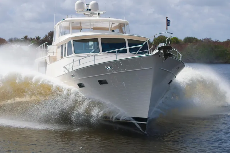 Slide: The Image of Luxury Fleming 85 yacht cruising through water, 2023 model, creating dynamic waves. - 77