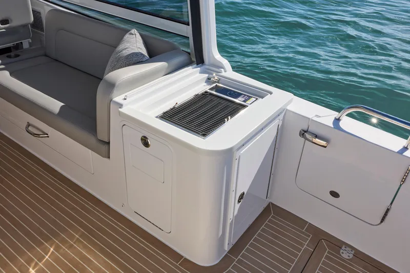 Slide: The Image of Luxury MJM 38x 2026 boat interior with seating and grill, overlooking water. - 18