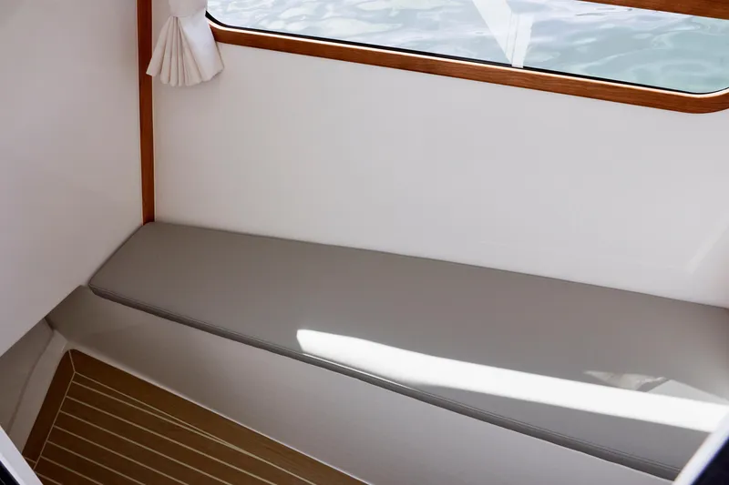 Slide: The Image of Interior of 2026 MJM 38x boat with cushioned seating and wooden accents. - 20