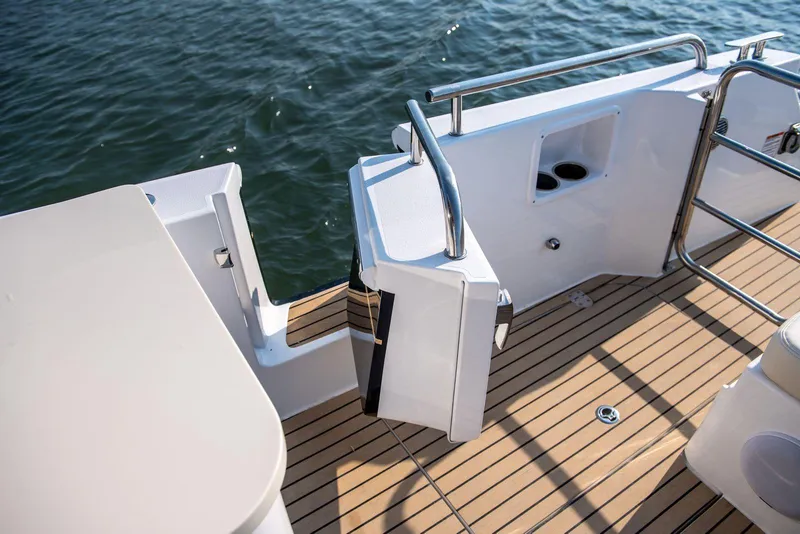 Slide: The Image of 2025 MJM 3 boat deck with teak flooring and stainless steel railings. - 21