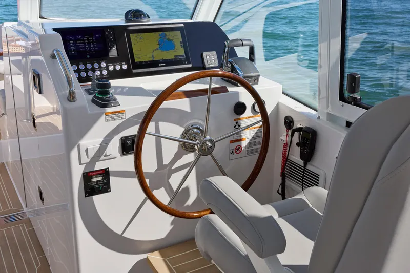 Slide: The Image of Helm of 2026 MJM 38x boat with modern navigation equipment and wooden steering wheel. - 8