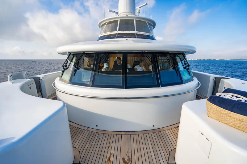 Slide: The Image of Luxury 2005 New Zealand Yachts 115 Wave Piercer on open sea, featuring sleek design and spacious deck. - 11