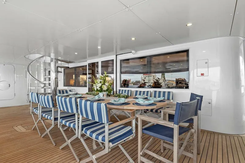 Slide: The Image of Luxurious dining area on 2005 New Zealand Yachts 115 Wave Piercer with striped chairs. - 32