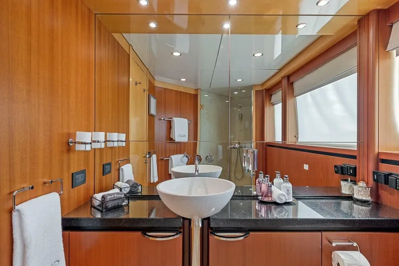 Slide: The Image of Luxurious bathroom on 2005 New Zealand Yachts 115 Wave Piercer, featuring modern fixtures and elegant wood paneling. - 48
