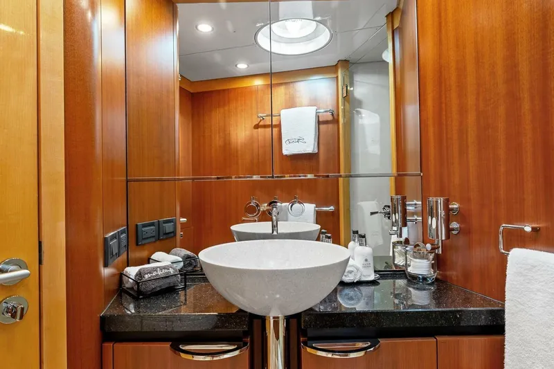Slide: The Image of Luxurious bathroom on 2005 New Zealand Yachts 115 Wave Piercer, featuring elegant wood paneling and modern fixtures. - 53