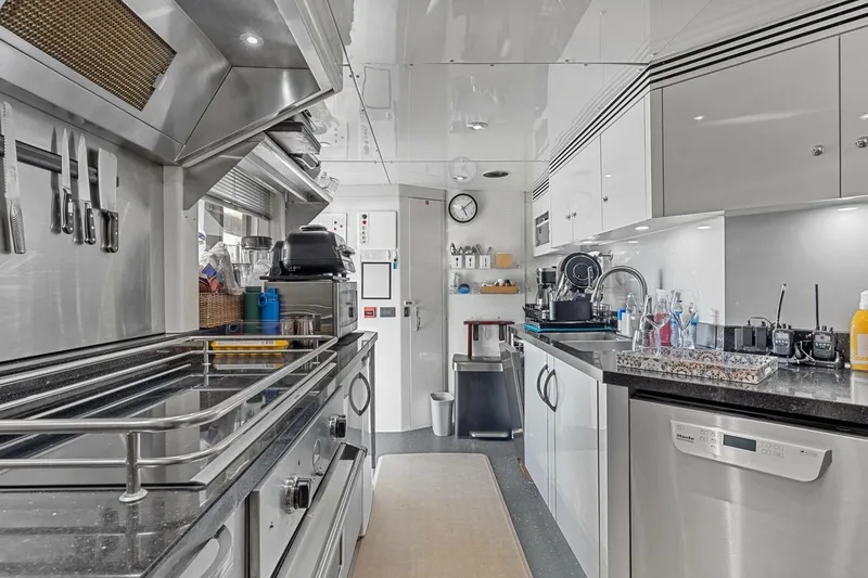 Slide: The Image of Modern yacht kitchen interior with stainless steel appliances, sleek countertops, and organized utensils. - 59