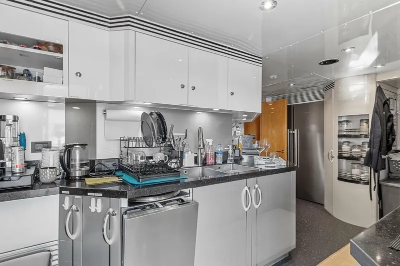 Slide: The Image of Modern kitchen interior on 2005 New Zealand Yachts 115 Wave Piercer, featuring sleek cabinetry and appliances. - 61