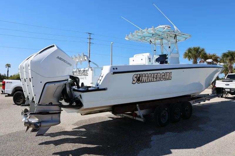 Slide: The Image of 2003 Contender 36 Open boat named "Summergirl" on trailer with Mercury engines. - 12