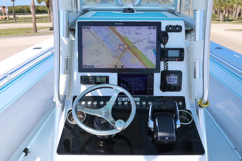 Slide: The Image of 2003 Contender 36 Open boat dashboard with navigation system and controls. - 17