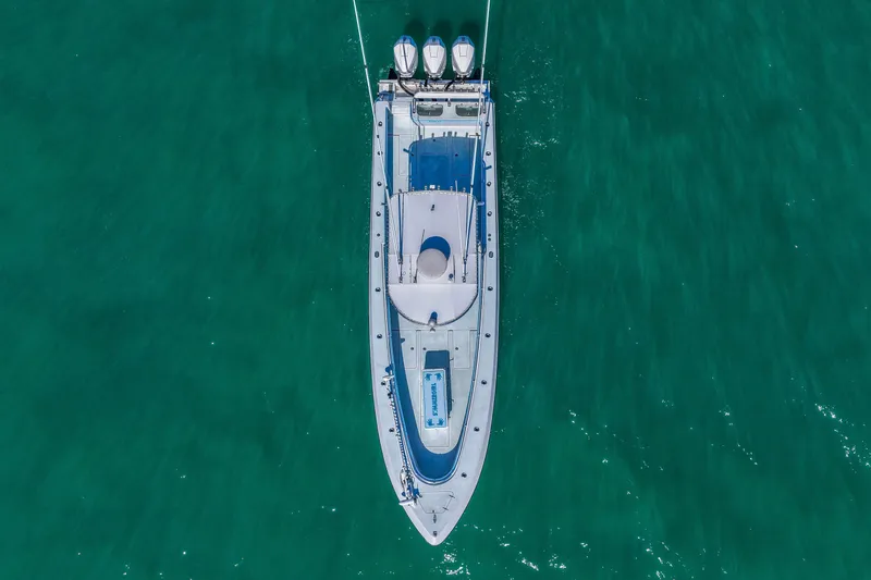 Slide: The Image of Aerial view of 2003 Contender 36 Open boat on clear turquoise water. - 2