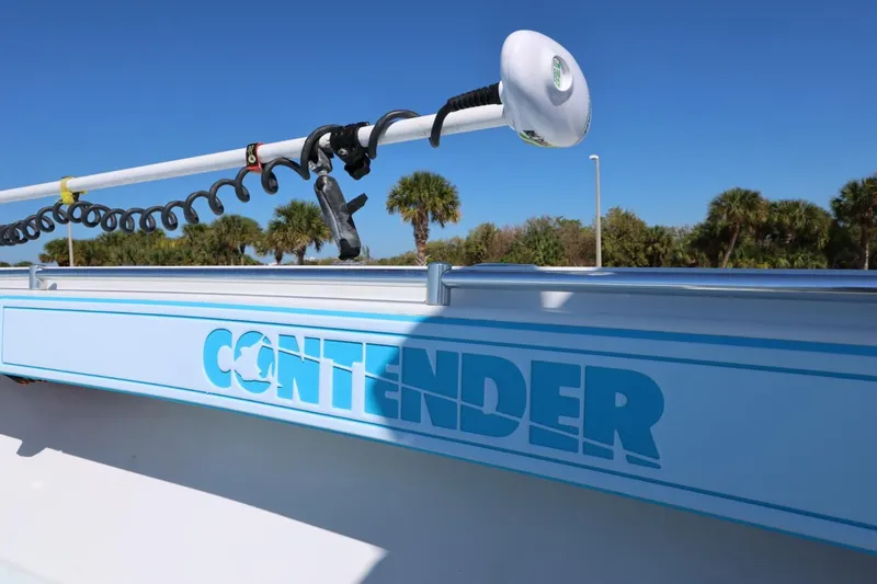 Slide: The Image of 2003 Contender 36 Open boat with logo, clear sky, and palm trees in background. - 20