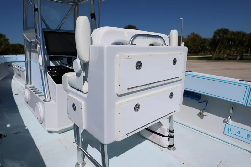 Slide: The Image of 2003 Contender 36 Open boat interior with white seating and storage compartments. - 21