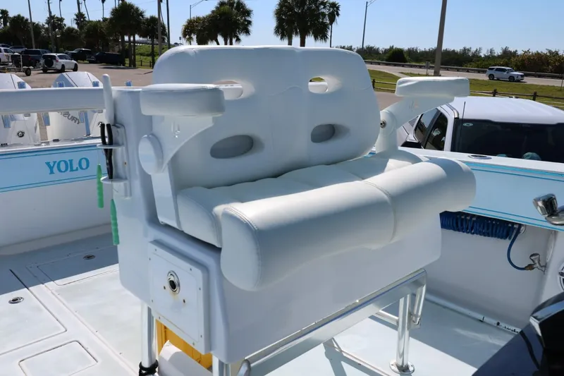 Slide: The Image of White cushioned seating on 2003 Contender 36 Open boat, parked near palm trees. - 22