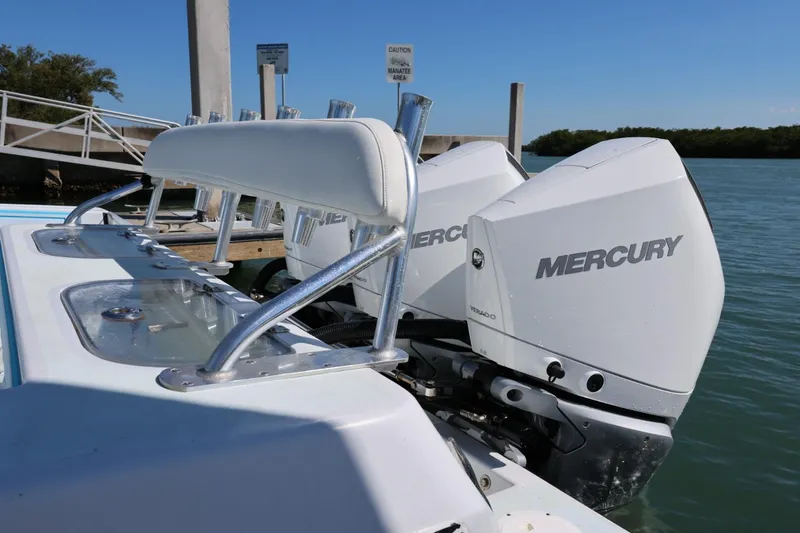 Slide: The Image of 2003 Contender 36 Open boat with dual Mercury outboard engines at a dock. - 25