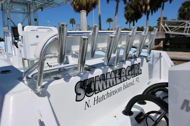 Slide: The Image of 2003 Contender 36 Open boat with rod holders, labeled "Summergirl," docked at N. Hutchinson Island, FL. - 26
