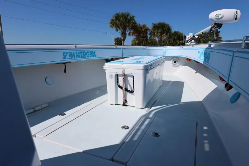 Slide: The Image of 2003 Contender 36 Open boat deck with cooler, clear sky, and palm trees. - 27