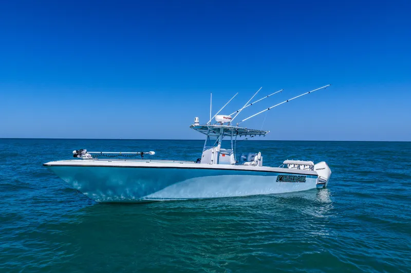 Slide: The Image of 2003 Contender 36 Open boat on calm blue ocean under clear sky. - 36