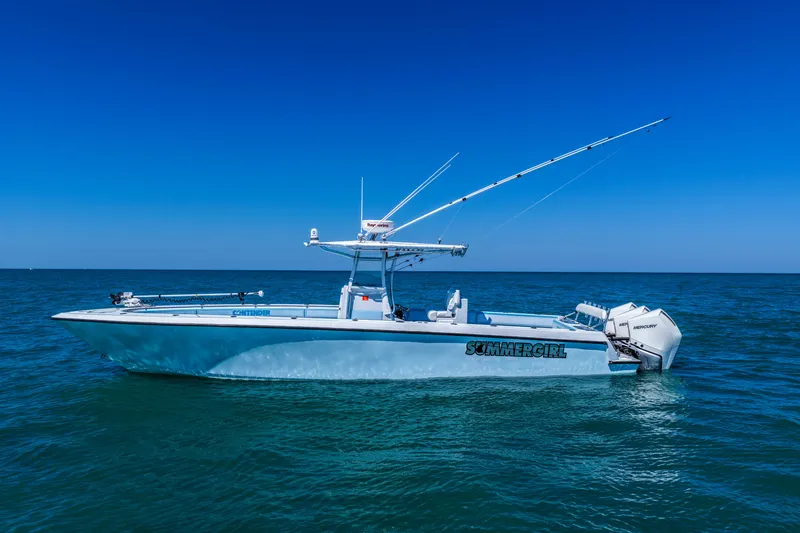 Slide: The Image of 2003 Contender 36 Open boat on calm ocean under clear blue sky. - 37