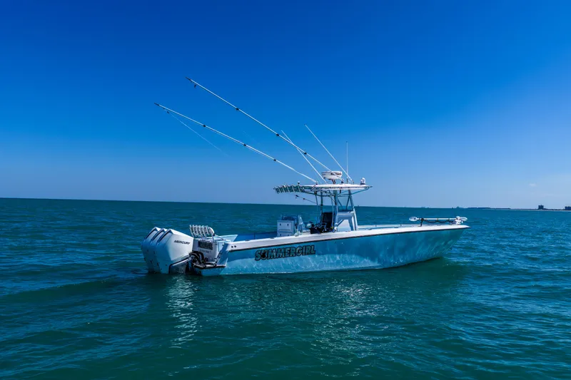 Slide: The Image of 2003 Contender 36 Open boat on calm blue ocean under clear sky. - 40