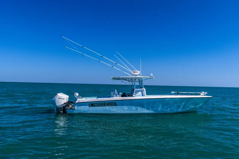 Slide: The Image of 2003 Contender 36 Open boat on calm blue ocean under clear sky. - 41