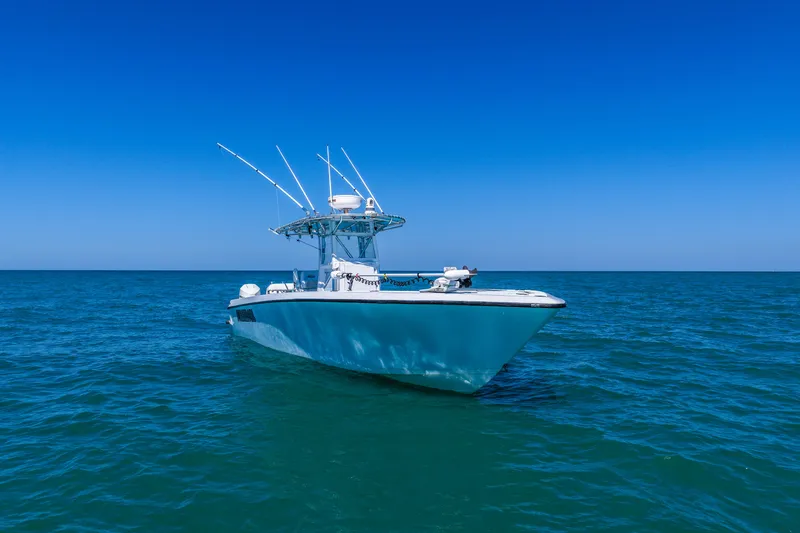 Slide: The Image of 2003 Contender 36 Open boat on calm blue ocean under clear sky. - 43