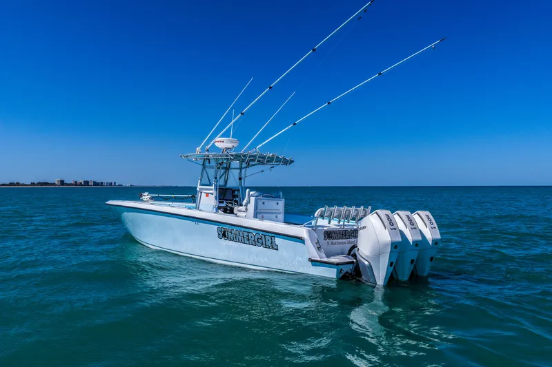 Slide: The Image of 2003 Contender 36 Open boat on calm ocean with clear blue sky. - 44