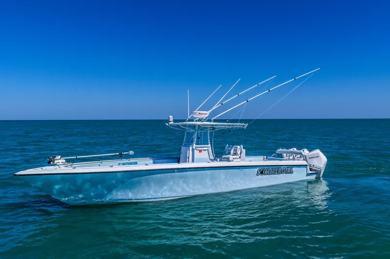 Slide: The Image of 2003 Contender 36 Open boat on calm blue ocean under clear sky. - 46