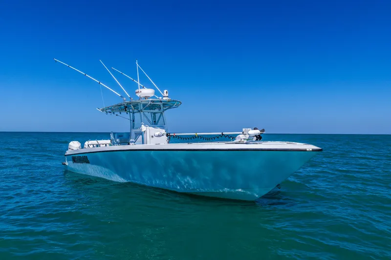 Slide: The Image of 2003 Contender 36 Open boat on calm blue ocean under clear sky. - 5