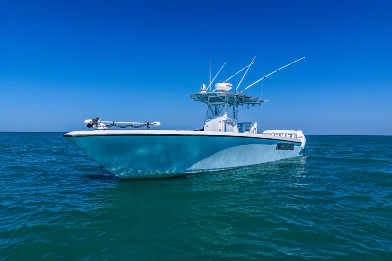 Slide: The Image of 2003 Contender 36 Open boat on calm blue ocean under clear sky. - 7