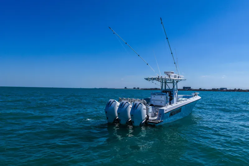 Slide: The Image of 2003 Contender 36 Open boat with dual engines on open sea under clear blue sky. - 9