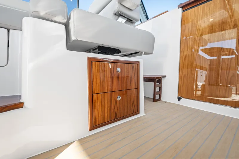 Slide: The Image of Luxury interior of 2026 MJM 47 R yacht with sleek wooden cabinetry and modern seating. - 12