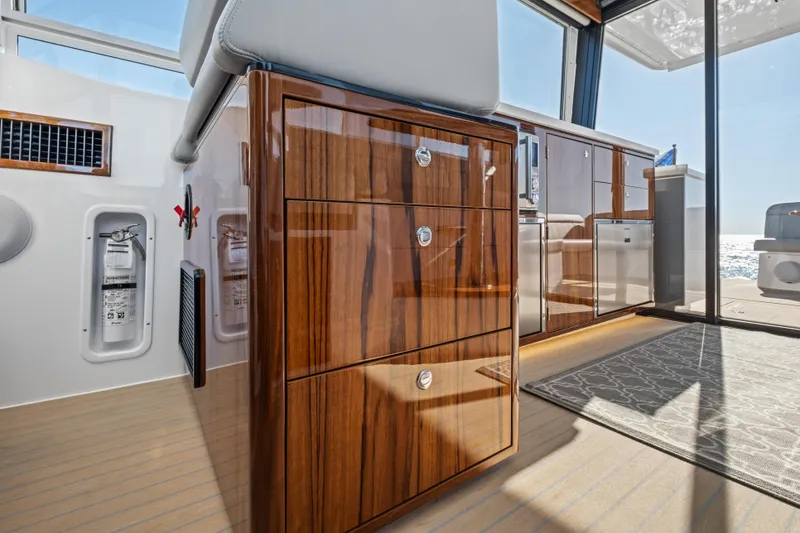 Slide: The Image of Luxurious interior of 2026 MJM 47 R yacht with polished wood cabinetry and ocean view. - 14