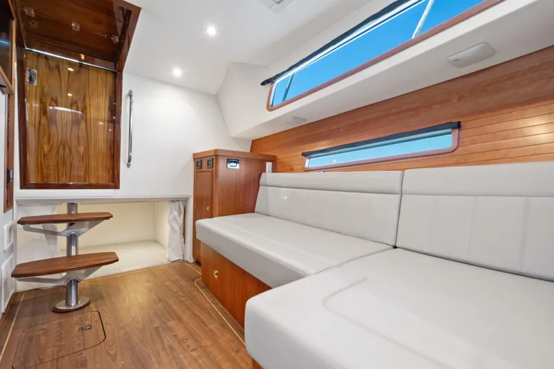 Slide: The Image of Luxurious interior of 2026 MJM 47 R yacht with sleek wood and white seating. - 19