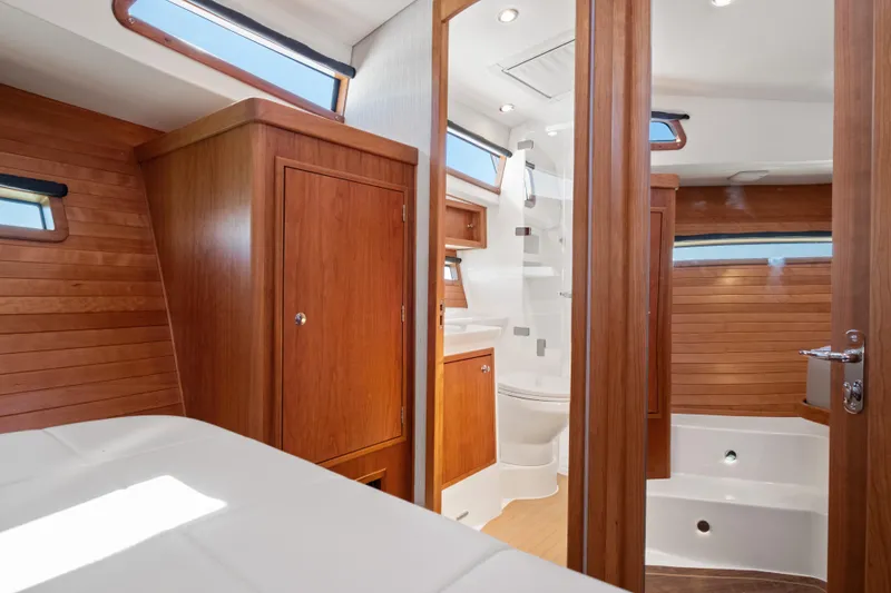 Slide: The Image of Luxurious interior of 2026 MJM 47 R yacht featuring wood paneling and modern bathroom. - 26