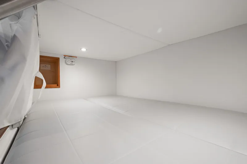 Slide: The Image of Interior cabin of 2026 MJM 47 R yacht, featuring a cozy white sleeping area. - 30