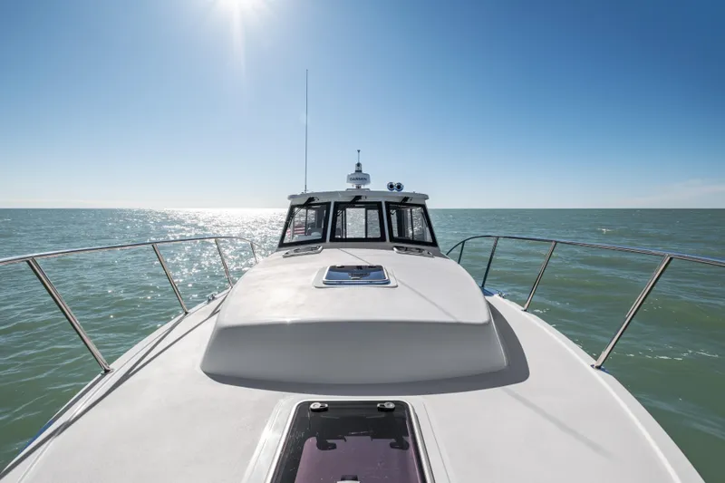 Slide: The Image of 2026 MJM 47 R yacht cruising on open sea under clear blue sky. - 32