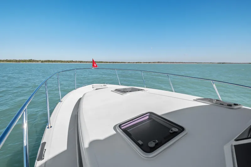 Slide: The Image of MJM 47 R 2026 yacht cruising on serene blue waters under clear skies. - 33