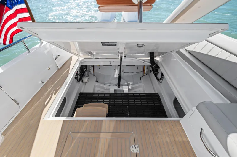 Slide: The Image of Open engine compartment of 2026 MJM 47 R yacht with American flag in background. - 36