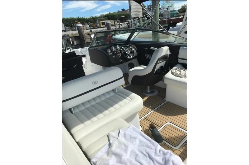 Slide: The Image of 2016 Cobalt R5 boat interior with white seating and wooden flooring. - 3