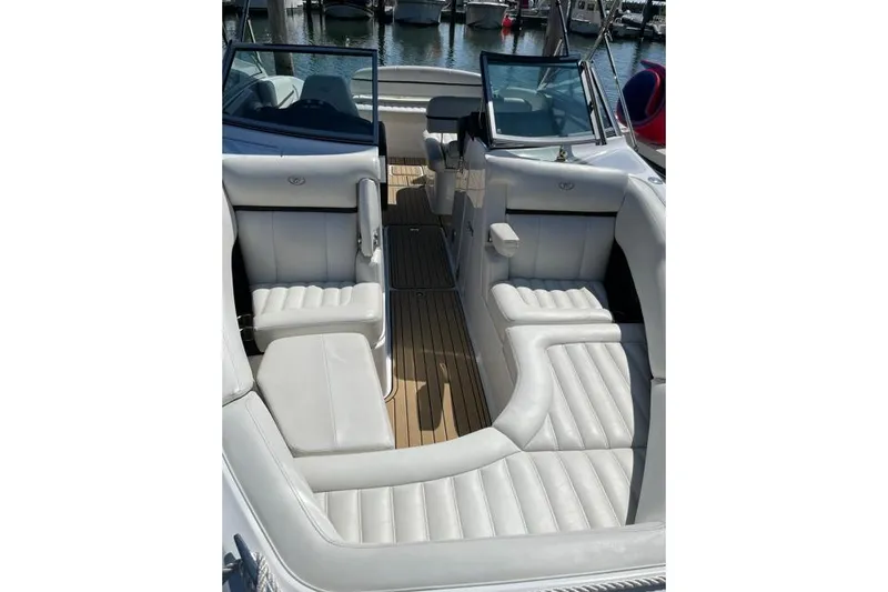 Slide: The Image of 2016 Cobalt R5 boat interior with white leather seating and wooden flooring. - 4