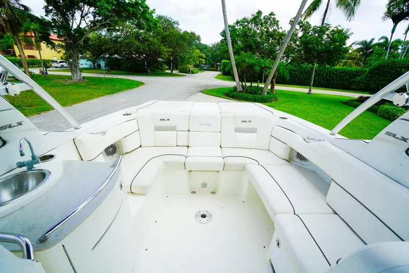 Slide: The Image of Luxurious 2010 Sea Ray 270 SLX boat interior with white seating and built-in sink. - 11