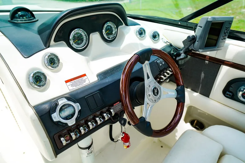 Slide: The Image of Dashboard of 2010 Sea Ray 270 SLX boat with steering wheel and gauges. - 17