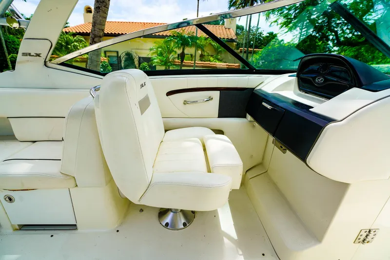 Slide: The Image of Interior of 2010 Sea Ray 270 SLX boat with white seating and dashboard. - 19