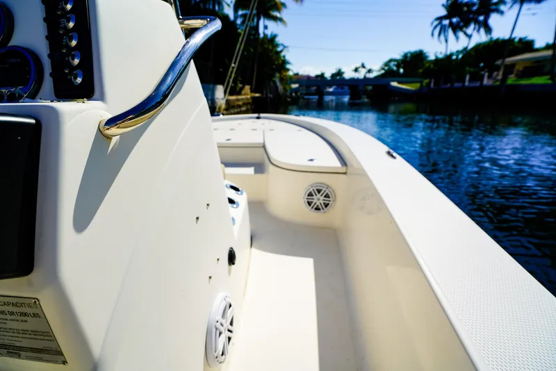 Slide: The Image of 2016 Robalo 206 Cayman boat interior on a sunny day by a canal. - 12