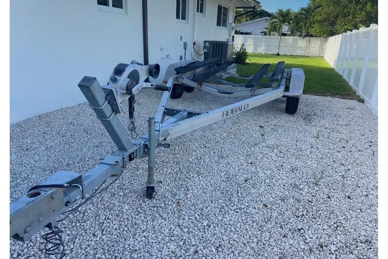 Slide: The Image of Trailer for 2016 Robalo 206 Cayman boat on gravel driveway. - 20